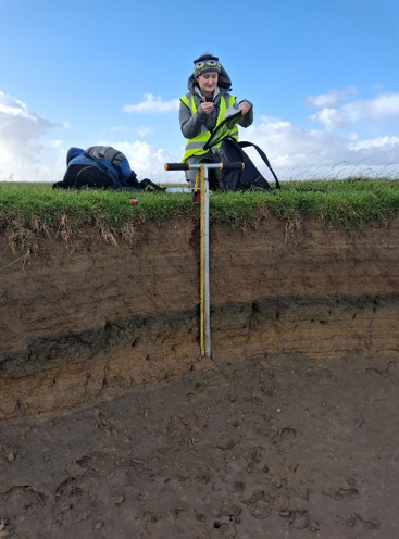 Using an auger to collect sediment cores in Scotland